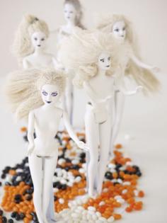 barbies spray-painted white make downright frightening decorations. (called "dolls of the living dead")