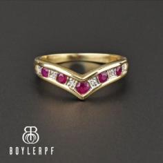 Beautiful vintage yellow gold ring that takes on a wishbone chevron shape covered with rich ruby and diamond gemstones. Having a V shape with an ornate design, the synthetic ruby and diamonds are all open back and cover the front of the ring. Wear as a midi or thumb ring or even as an alternative wedding band.