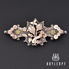 Beautiful Victorian brooch pin features delightful design with raised rose gold and yellow gold leaves, forget me not flowers and the back having a horseshoe. The sterling silver pin has full English hallmarks dating to 1900 and hailing from Birmingham, England. The perfect sweetheart brooch great for the gents lapel or the for the ladies!