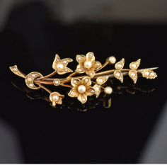 Beautiful and outstanding Victorian antique floral pearl brooch in a striking 15K gold, circa late 1800s. The delicate seed pearls are set into an openwork floral pattern and gathered at the bottom. A truly splendid piece of antique jewelry that would look beautiful worn as a brooch, suspended from a long silk ribbon cord, or from a fine chain!
