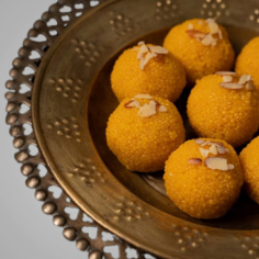 Indulge in the exquisite taste of Kandoi Bhogilal Mulchand's Motichur Ladoo, a beloved Indian sweet delicacy. Crafted with the finest ingredients and time-honored techniques, each bite offers a burst of sweet flavors and a satisfyingly delicate texture. Whether celebrating a special occasion or simply treating yourself, these delectable sweets are sure to delight your taste buds and evoke memories of tradition and celebration.