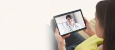 A patient engages in a virtual medical consultation with a smiling healthcare professional on a tablet, symbolizing the convenience and personal touch of telehealth services.


